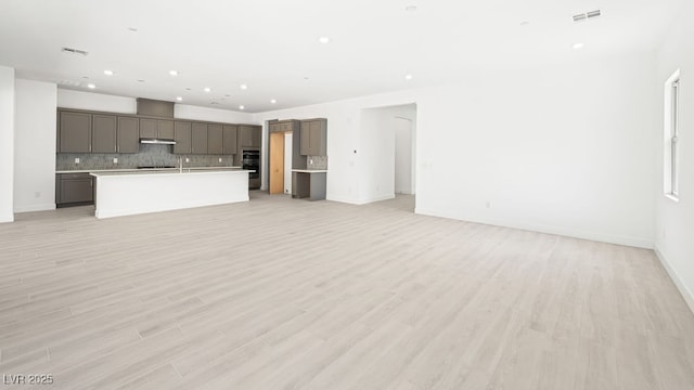 362 Tigullio Ave, Henderson, NV 89011 - unfurnished living room with recessed lighting, light wood-type flooring, and baseboards