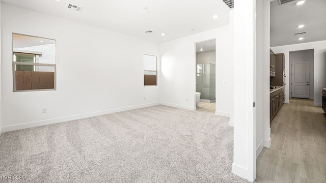 362 Tigullio Ave, Henderson, NV 89011 - unfurnished room with baseboards, recessed lighting, light colored carpet, and light wood finished floors