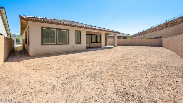 362 Tigullio Ave, Henderson, NV 89011 - back of property with stucco siding, a fenced backyard, a tile roof, and a patio area