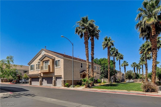 67 Dow Jones St Unit 2, Henderson, NV 89074 - view of building exterior featuring an attached garage and a residential view
