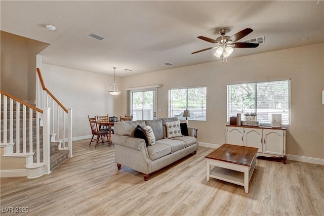 67 Dow Jones St Unit 2, Henderson, NV 89074 - living room with light wood-type flooring, baseboards, and stairs