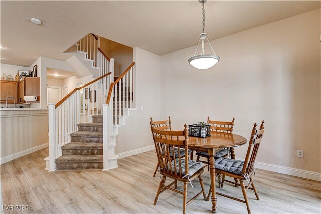 67 Dow Jones St Unit 2, Henderson, NV 89074 - dining area with light wood-style flooring, stairs, and baseboards