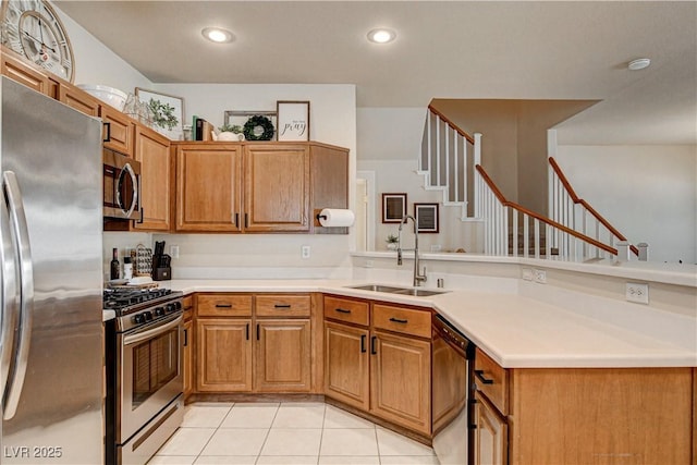 67 Dow Jones St Unit 2, Henderson, NV 89074 - kitchen featuring appliances with stainless steel finishes, a sink, a peninsula, light tile patterned floors, and recessed lighting