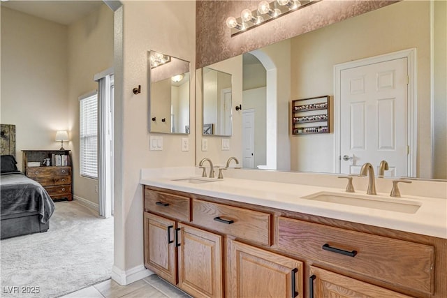 67 Dow Jones St Unit 2, Henderson, NV 89074 - bathroom with double vanity, ensuite bath, baseboards, and tile patterned flooring