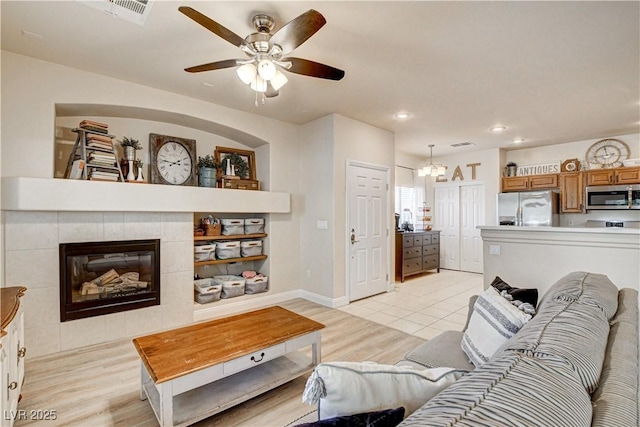 67 Dow Jones St Unit 2, Henderson, NV 89074 - living area with ceiling fan, light wood-style flooring, recessed lighting, a chandelier, and a tile fireplace