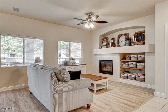 67 Dow Jones St Unit 2, Henderson, NV 89074 - living area featuring a tile fireplace, a ceiling fan, baseboards, and wood finished floors