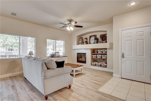 67 Dow Jones St Unit 2, Henderson, NV 89074 - living room with a ceiling fan, light wood finished floors, a tiled fireplace, baseboards, and recessed lighting