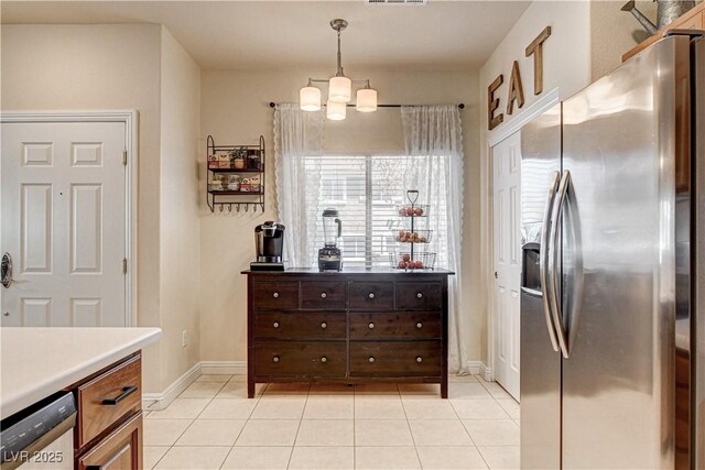 67 Dow Jones St Unit 2, Henderson, NV 89074 - kitchen featuring stainless steel refrigerator with ice dispenser, light tile patterned flooring, dishwasher, light countertops, and pendant lighting