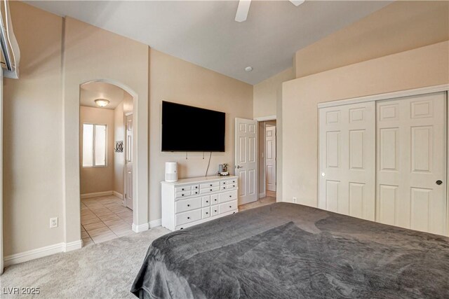 67 Dow Jones St Unit 2, Henderson, NV 89074 - bedroom with arched walkways, light carpet, vaulted ceiling, a closet, and baseboards