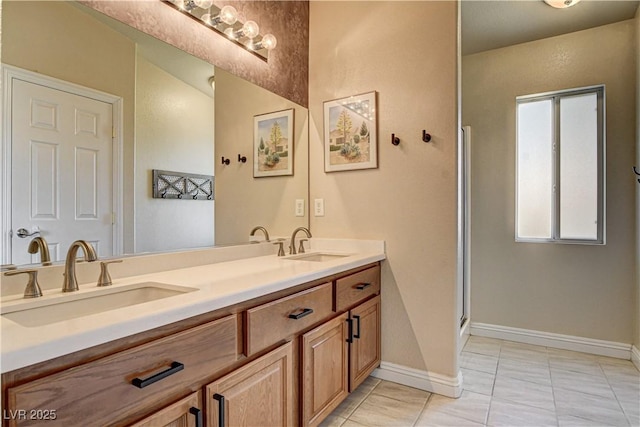 67 Dow Jones St Unit 2, Henderson, NV 89074 - bathroom with double vanity, baseboards, and a shower with door