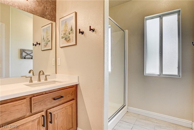 67 Dow Jones St Unit 2, Henderson, NV 89074 - full bathroom with a shower stall, vanity, baseboards, and healthy amount of natural light