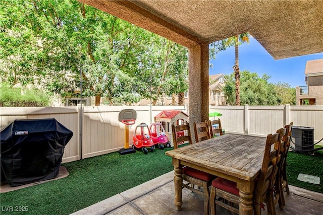 67 Dow Jones St Unit 2, Henderson, NV 89074 - fenced backyard with cooling unit, a patio area, and outdoor dining area
