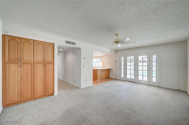3143 El Chico Ct, Las Vegas, NV 89120 - unfurnished living room featuring light carpet, ceiling fan, a textured ceiling, and baseboards