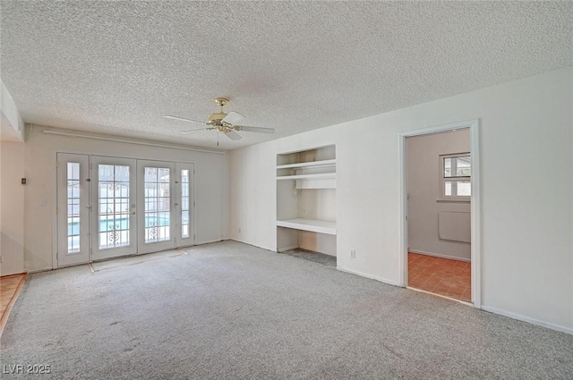 3143 El Chico Ct, Las Vegas, NV 89120 - carpeted spare room with a ceiling fan, a textured ceiling, baseboards, and built in shelves