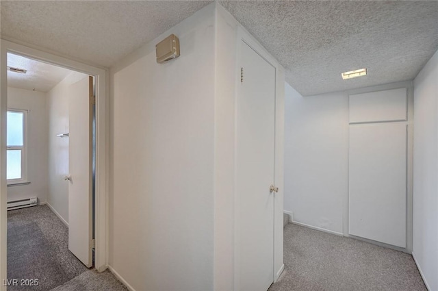 3143 El Chico Ct, Las Vegas, NV 89120 - corridor featuring a textured ceiling, carpet, a baseboard heating unit, and baseboards