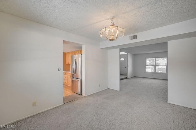3143 El Chico Ct, Las Vegas, NV 89120 - spare room with light carpet, a chandelier, a textured ceiling, and baseboards