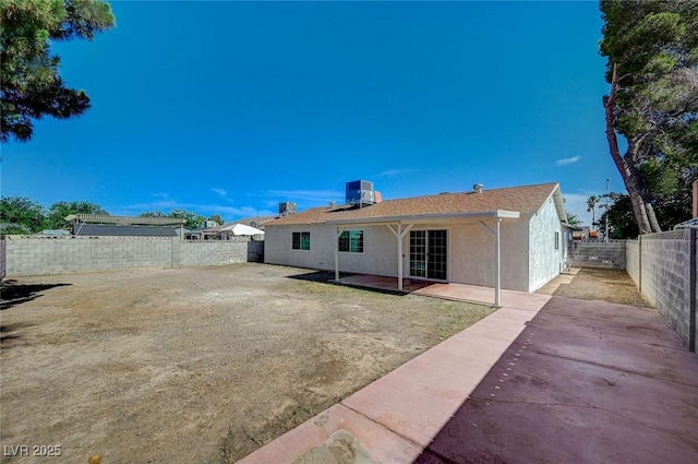 4496 Skyview Dr, Las Vegas, NV 89104 - back of property featuring stucco siding, central air condition unit, a patio, and a fenced backyard