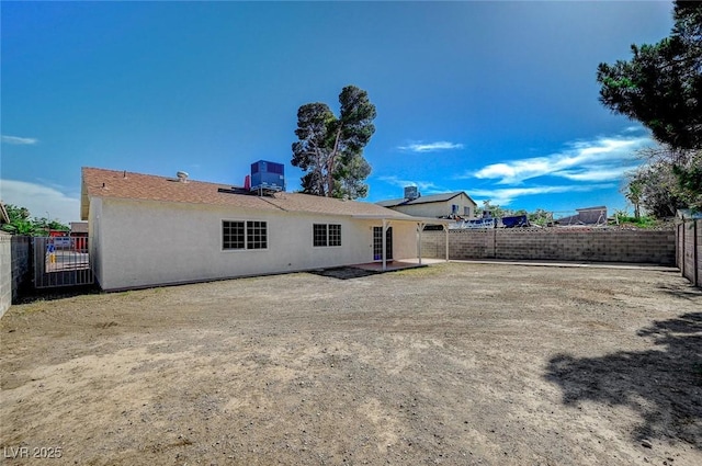 4496 Skyview Dr, Las Vegas, NV 89104 - rear view of house with a fenced backyard, cooling unit, stucco siding, and a patio area