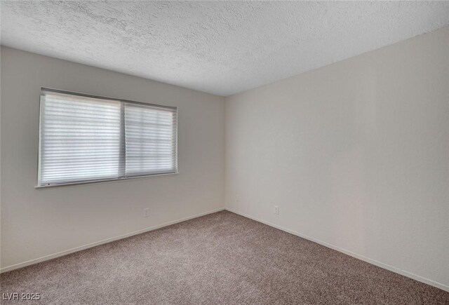 4496 Skyview Dr, Las Vegas, NV 89104 - empty room with carpet, a textured ceiling, and baseboards