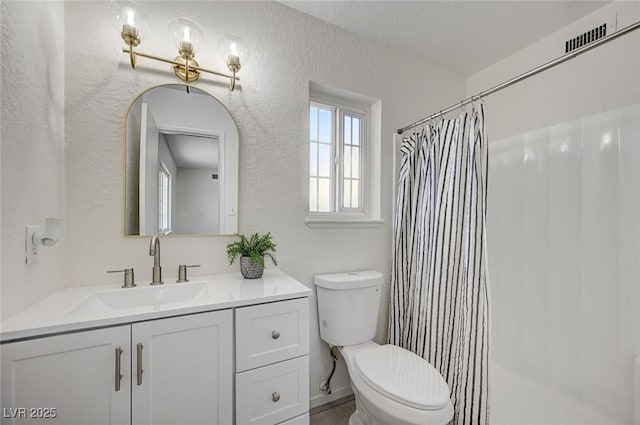 4496 Skyview Dr, Las Vegas, NV 89104 - bathroom featuring a textured wall, vanity, toilet, and a shower with shower curtain