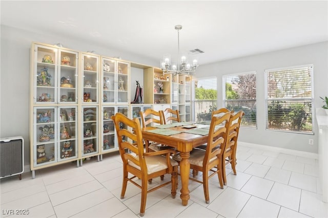 3966 Crystal Trip Ct, Las Vegas, NV 89129 - dining area with a chandelier, light tile patterned flooring, and baseboards