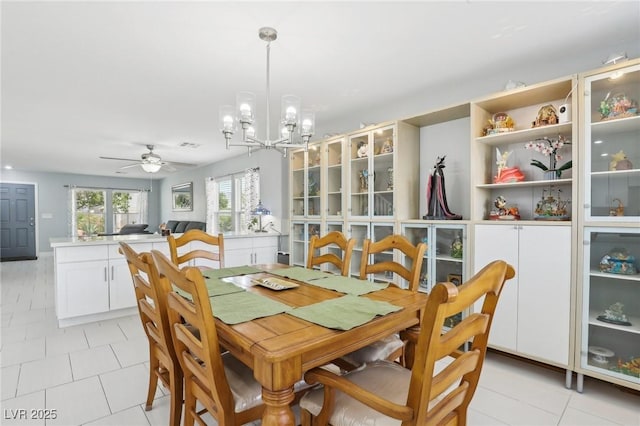 3966 Crystal Trip Ct, Las Vegas, NV 89129 - dining area featuring a chandelier, a ceiling fan, and light tile patterned floors