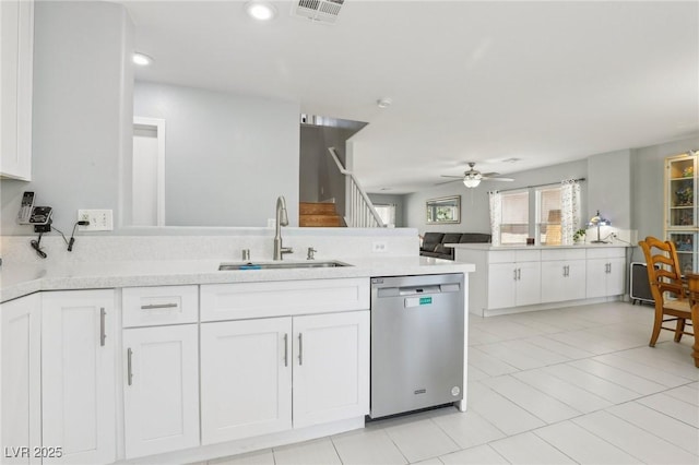 3966 Crystal Trip Ct, Las Vegas, NV 89129 - kitchen featuring stainless steel dishwasher, a sink, a peninsula, a ceiling fan, and white cabinetry