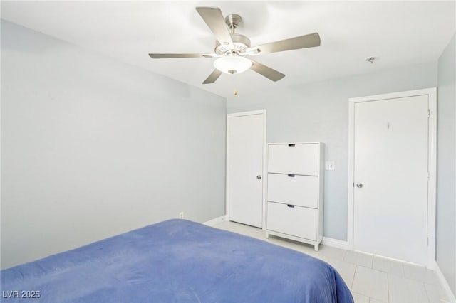 3966 Crystal Trip Ct, Las Vegas, NV 89129 - bedroom with light tile patterned floors, baseboards, and a ceiling fan