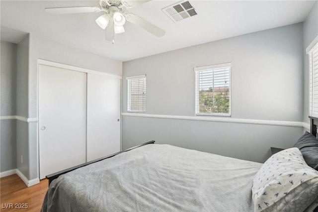 3966 Crystal Trip Ct, Las Vegas, NV 89129 - bedroom with wood finished floors, a closet, baseboards, and a ceiling fan