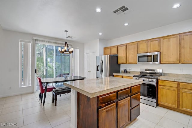 2851 Glistening Grove Ave, Henderson, NV 89052 - kitchen with appliances with stainless steel finishes, a chandelier, recessed lighting, hanging light fixtures, and light tile patterned flooring