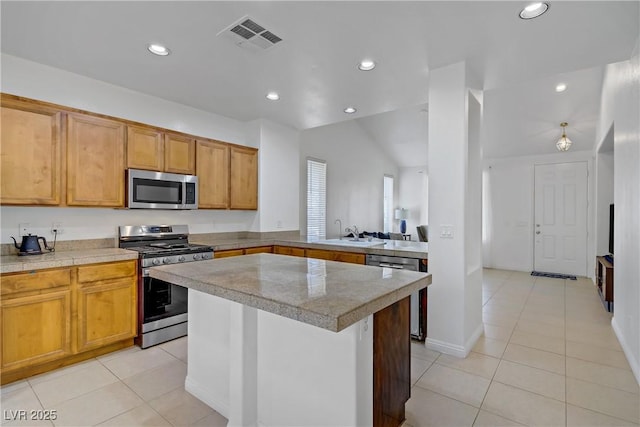 2851 Glistening Grove Ave, Henderson, NV 89052 - kitchen featuring appliances with stainless steel finishes, light tile patterned floors, a sink, recessed lighting, and a kitchen island