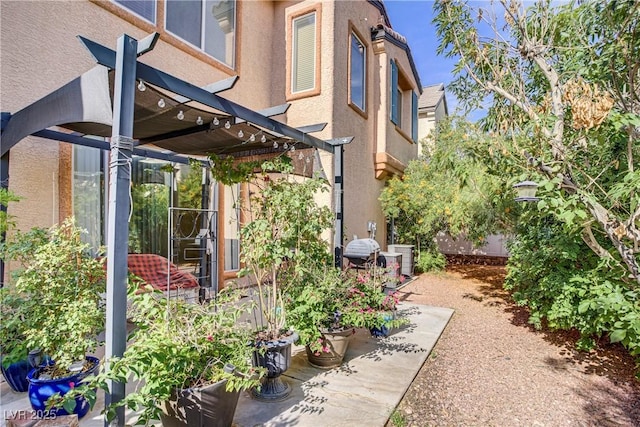 2851 Glistening Grove Ave, Henderson, NV 89052 - view of side of property with a pergola and stucco siding