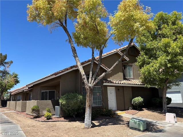 6908 Cornflower Dr, Las Vegas, NV 89128 - view of front of property featuring stucco siding, a tile roof, and central AC unit