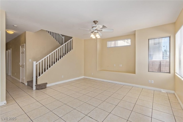 3037 Austin Pale Ave, North Las Vegas, NV 89081 - unfurnished room featuring stairs, light tile patterned flooring, ceiling fan, and baseboards