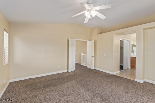 3037 Austin Pale Ave, North Las Vegas, NV 89081 - unfurnished bedroom featuring light carpet, vaulted ceiling, baseboards, and ceiling fan
