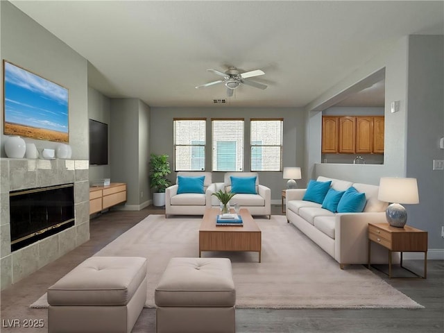 258 Bella Matese Ave, Las Vegas, NV 89183 - living room with a ceiling fan, baseboards, a fireplace, and wood finished floors