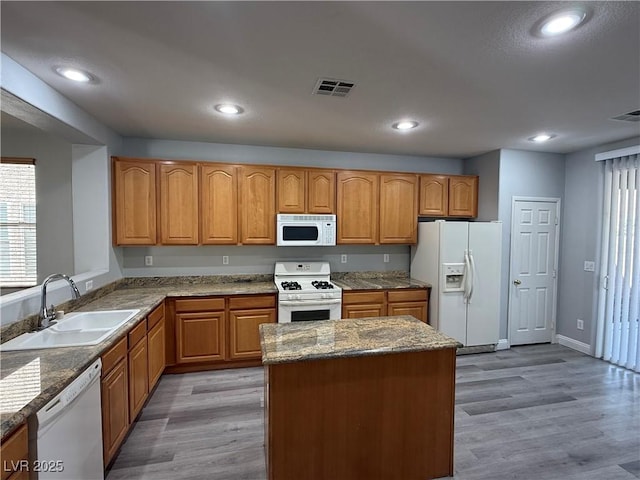 258 Bella Matese Ave, Las Vegas, NV 89183 - kitchen with white appliances, a sink, light wood-style floors, recessed lighting, and brown cabinetry