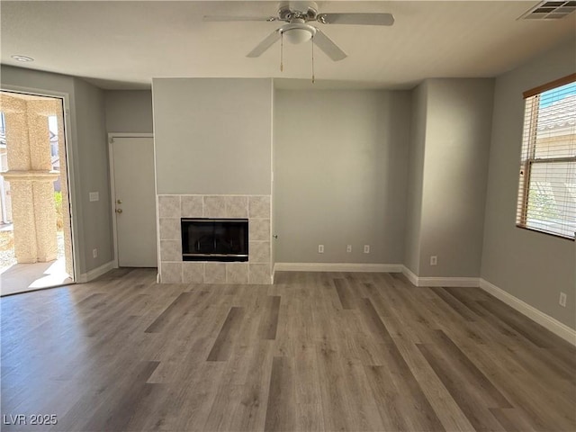 258 Bella Matese Ave, Las Vegas, NV 89183 - unfurnished living room featuring a fireplace, baseboards, wood finished floors, and ceiling fan