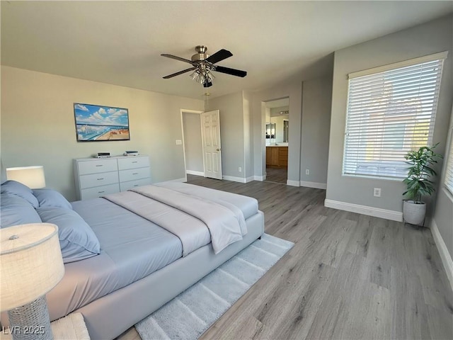 258 Bella Matese Ave, Las Vegas, NV 89183 - bedroom with light wood finished floors, baseboards, ensuite bath, and ceiling fan