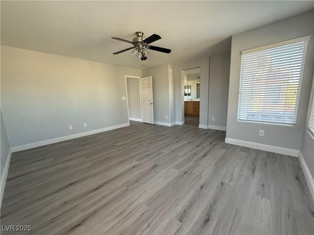 258 Bella Matese Ave, Las Vegas, NV 89183 - unfurnished bedroom featuring wood finished floors, baseboards, ensuite bath, and ceiling fan