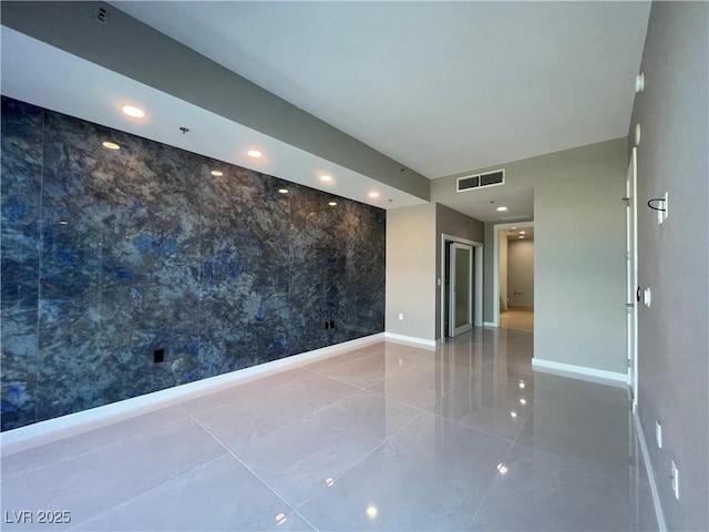 4525 Dean Martin Dr Unit 1507, Las Vegas, NV 89103 - unfurnished room with an accent wall, recessed lighting, tile patterned floors, and wallpapered walls