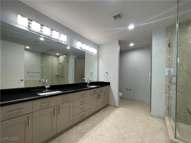 4525 Dean Martin Dr Unit 1507, Las Vegas, NV 89103 - bathroom featuring double vanity, a shower stall, and recessed lighting