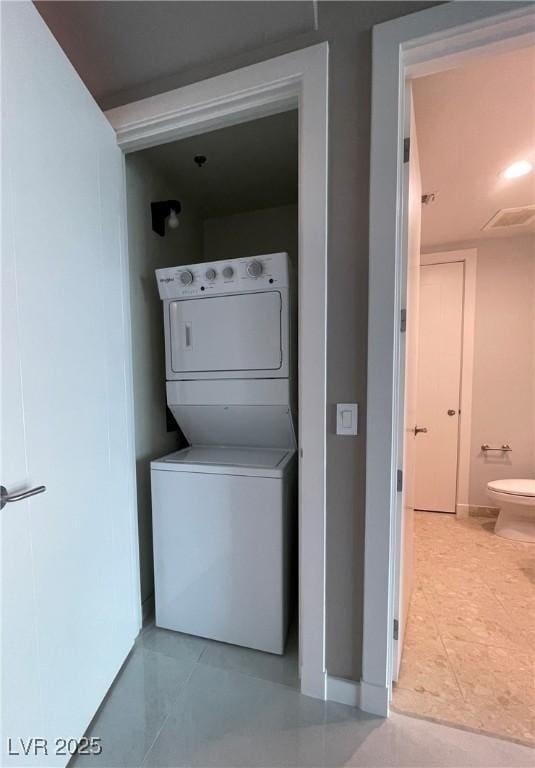 4525 Dean Martin Dr Unit 1507, Las Vegas, NV 89103 - washroom featuring stacked washing machine and dryer and tile patterned flooring