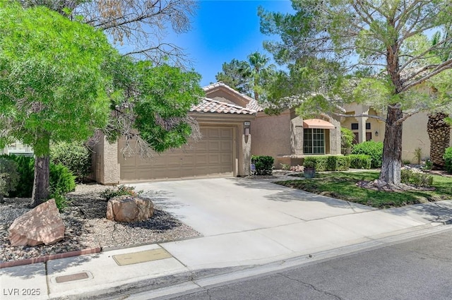9220 Evergreen Canyon Dr, Las Vegas, NV 89134 - mediterranean / spanish-style house featuring stucco siding, an attached garage, a tiled roof, and driveway