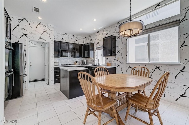 9220 Evergreen Canyon Dr, Las Vegas, NV 89134 - dining space featuring a chandelier, light tile patterned floors, and recessed lighting