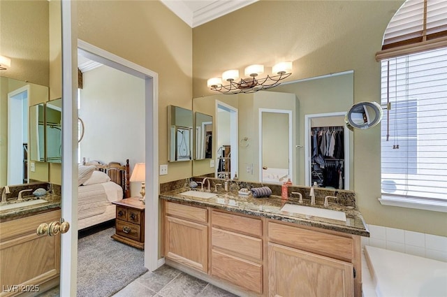 9220 Evergreen Canyon Dr, Las Vegas, NV 89134 - ensuite bathroom featuring double vanity, healthy amount of natural light, a bath, and tile patterned floors