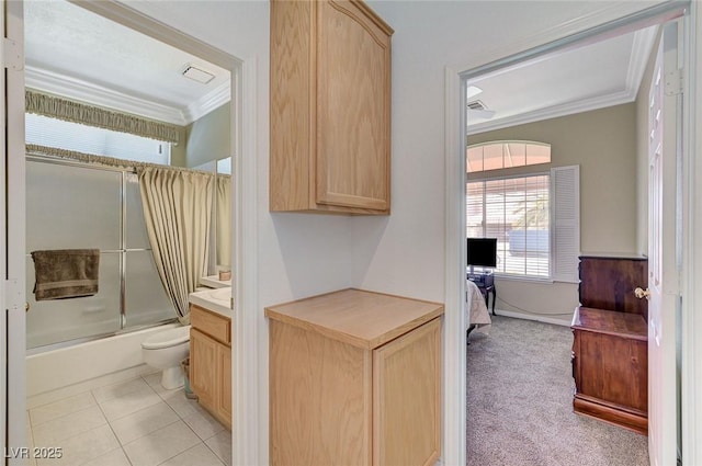 9220 Evergreen Canyon Dr, Las Vegas, NV 89134 - ensuite bathroom featuring ornamental molding, enclosed tub / shower combo, healthy amount of natural light, toilet, and vanity