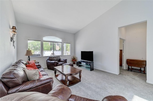 9220 Evergreen Canyon Dr, Las Vegas, NV 89134 - carpeted living area with vaulted ceiling and baseboards