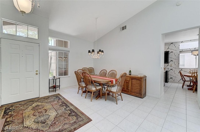 9220 Evergreen Canyon Dr, Las Vegas, NV 89134 - dining space featuring a chandelier, healthy amount of natural light, high vaulted ceiling, and light tile patterned flooring