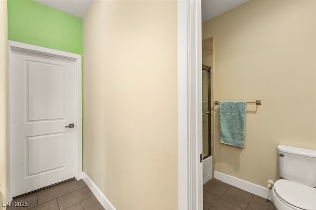 3159 Via Como, Henderson, NV 89044 - full bath with tile patterned floors, toilet, baseboards, and bath / shower combo with glass door